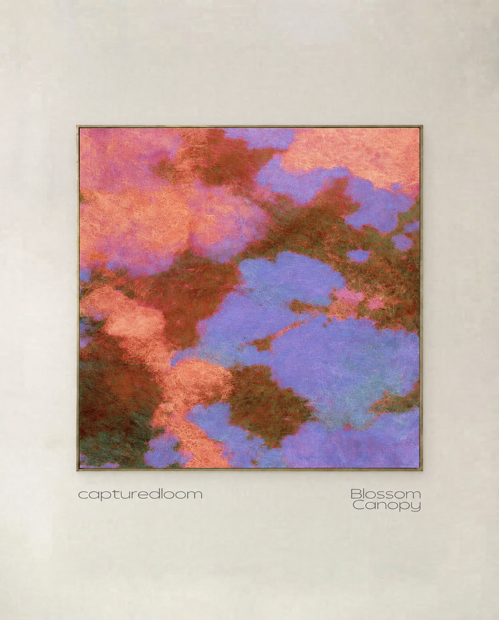 Blossom Canopy - coral and lilac blossom seen from above, threaded with bronze, shown in a thin gold frame on a pale wall