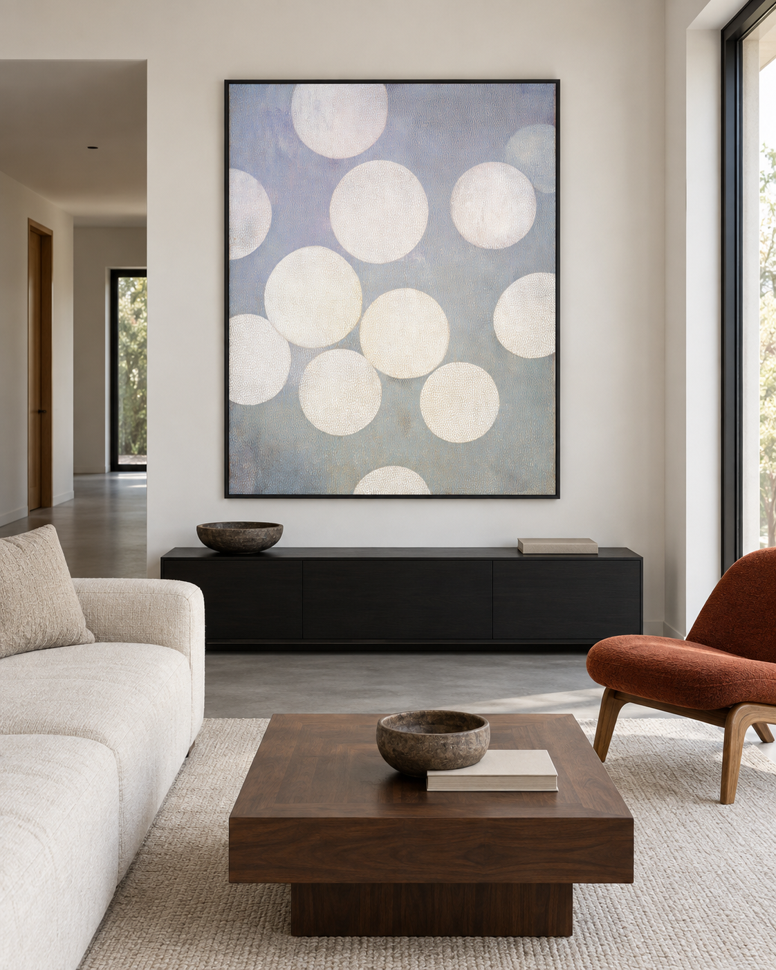 White Circles artwork above a dark sideboard in a quiet living room