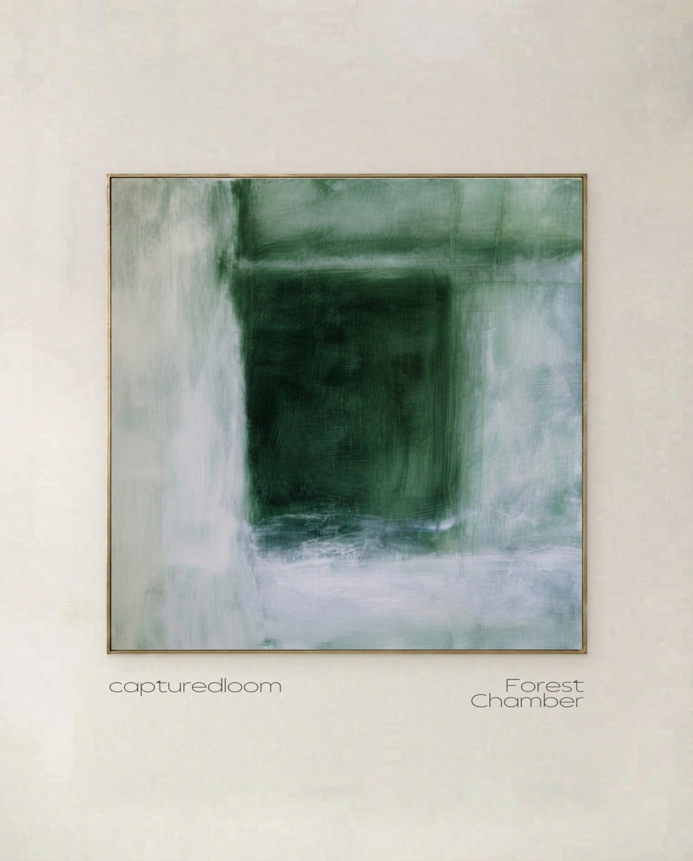 Forest Chamber - deep forest green abstract form dissolving into pale mist, shown in a thin gold frame on a pale wall